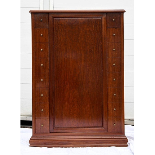 195 - A Chinese rosewood revolving bar in an Art Deco style, it houses various compartments for bottles, g... 