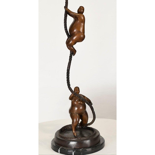 198 - A fabulous modern design of two climbing art figures on rope. Cast in bronze on a solid black marble... 