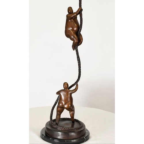 198 - A fabulous modern design of two climbing art figures on rope. Cast in bronze on a solid black marble... 