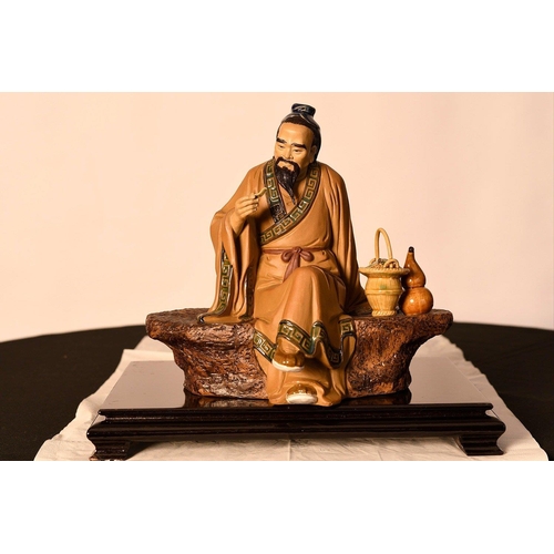 209 - A Shiwan original figure of a finely detailed man on a bench comes with a wooden plinth. Origin Fosh... 