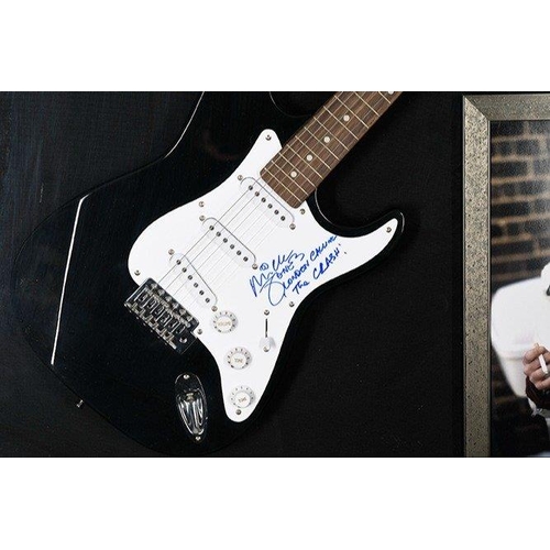 238 - A rare framed guitar which MICK JONES has signed the pick guard and also has signed the words 