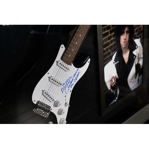 238 - A rare framed guitar which MICK JONES has signed the pick guard and also has signed the words 