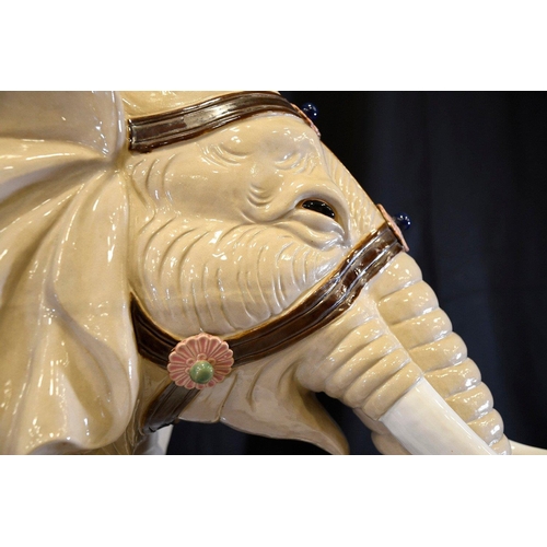 30 - An original Shiwan porcelain elephant which has been hand painted and decorated in fine detail. Orig... 