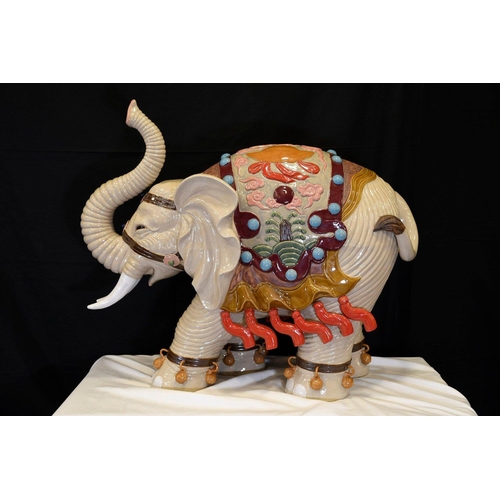 31 - An original Shiwan porcelain elephant which has been hand painted and decorated in fine detail. Orig... 