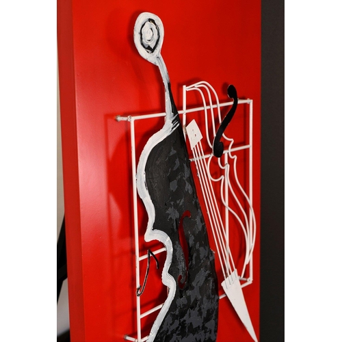 40 - This modern art piece has a red gloss frame panel with metal instrument attached which have been han... 