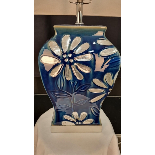 42 - A porcelain blue and silver hand painted lamp with embossed floral detail. Display shade shown suppl... 