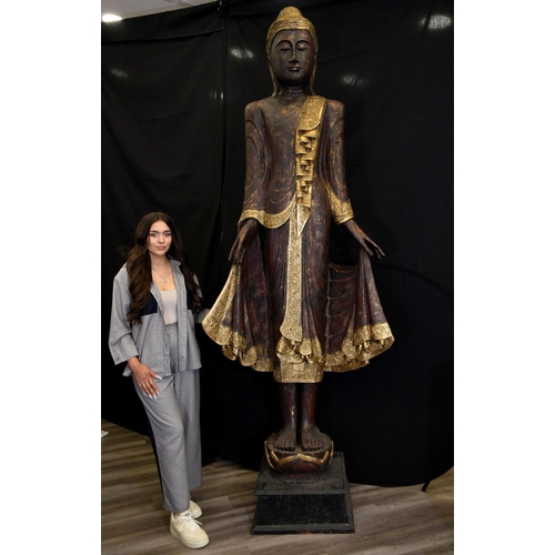 66 - An incredible 9ft high hand made wood carving of a Thai goddess hand decorated and finished with gol... 