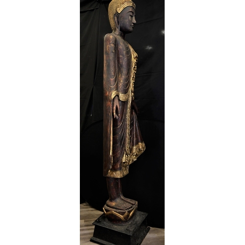 66 - An incredible 9ft high hand made wood carving of a Thai goddess hand decorated and finished with gol... 