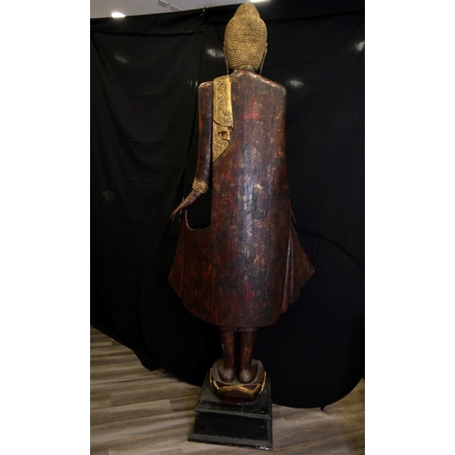 66 - An incredible 9ft high hand made wood carving of a Thai goddess hand decorated and finished with gol... 