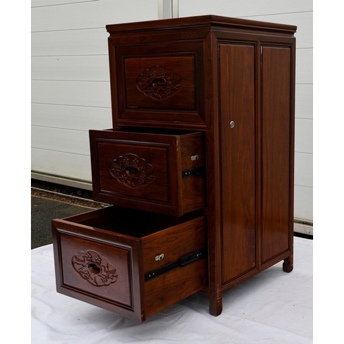 72 - A solid rosewood filing cabinet which houses three lockable drawers and displays a bird and flower m... 