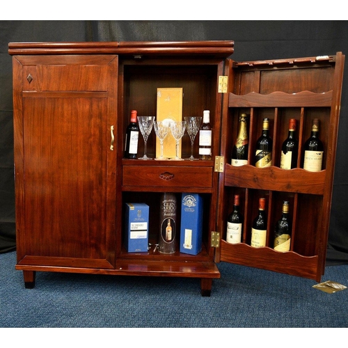 79 - A hand made rosewood folding bar with various compartments for bottles glasses and accoutrements (co... 