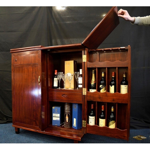 79 - A hand made rosewood folding bar with various compartments for bottles glasses and accoutrements (co... 