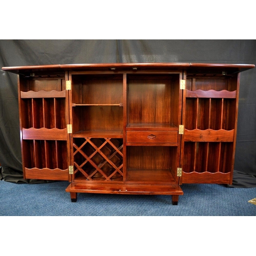 79 - A hand made rosewood folding bar with various compartments for bottles glasses and accoutrements (co... 