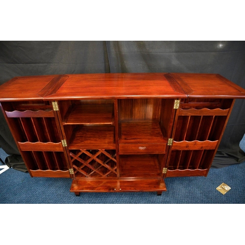 79 - A hand made rosewood folding bar with various compartments for bottles glasses and accoutrements (co... 