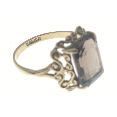 25 - A 9ct fully hallmarked ring with intricate mount and rectangular smokey quartz centre stone.  Size K... 