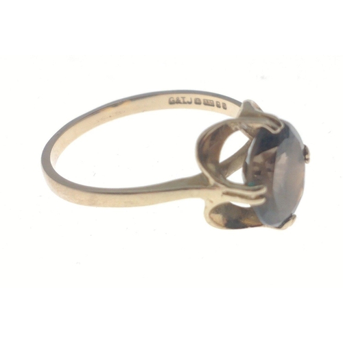 26 - A fully hallmarked gold ring with oval smokey quartz centre stone. Size O Total gross weight 1.9g ap... 