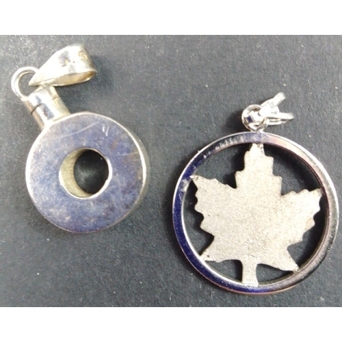 91 - A silver pendant, polo mint-shaped, 15mm long stamped 925 and a maple shaped pendant with indistinct... 