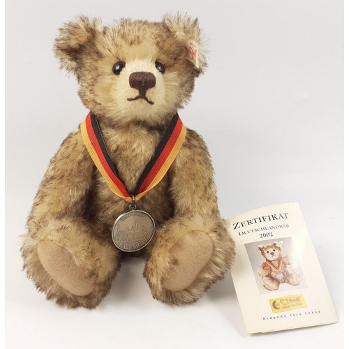 296 - A STEIFF tourism teddy bear, reference 671135, stands 22cm high, produced 2002, with mohair fur and ... 