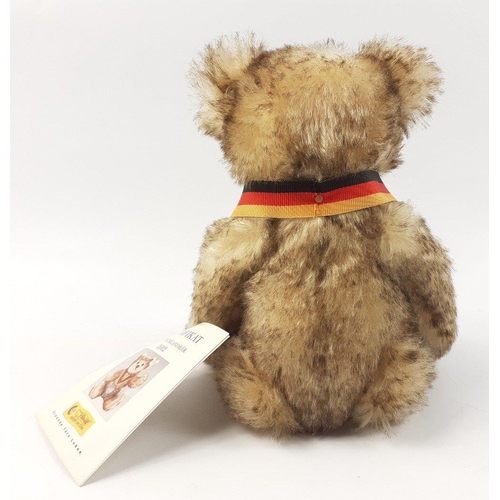 296 - A STEIFF tourism teddy bear, reference 671135, stands 22cm high, produced 2002, with mohair fur and ... 