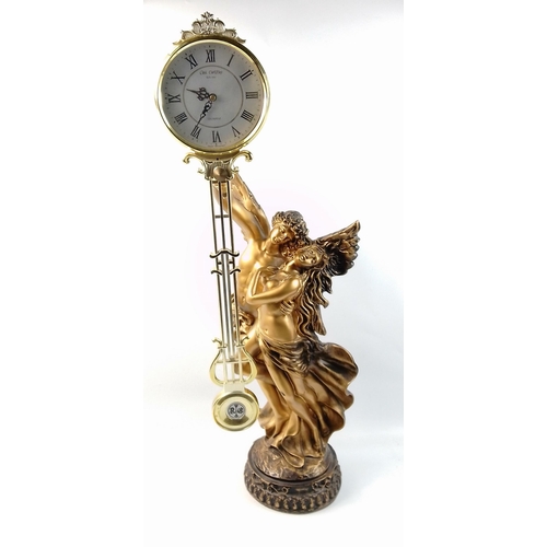 120 - A large ormolu style classical couple supporting a modern pendulum clock.  Stands an impressive 77cm... 