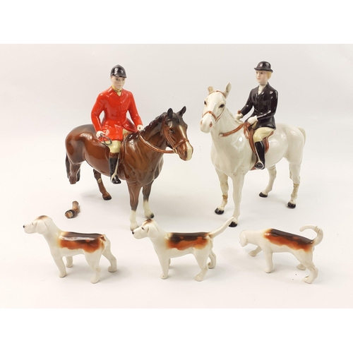 205 - A BESWICK hunt group comprising one male and one female figure plus 3 dogs, all with damage and evid... 