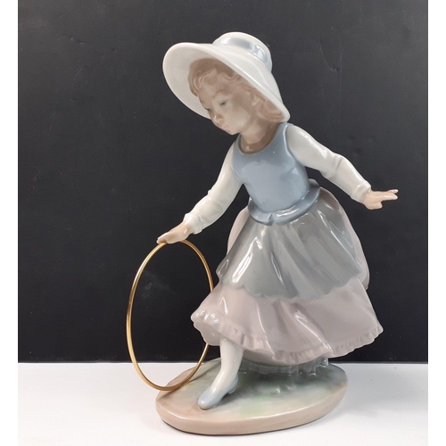 207 - A pretty NAO young girl playing with hoop, stands 20cm high, in good condition#207