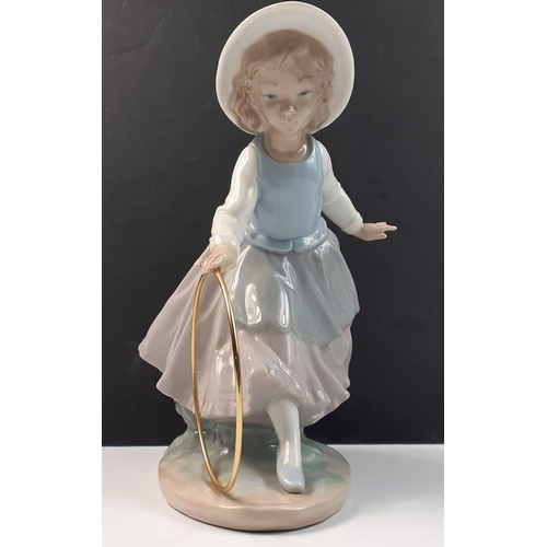 207 - A pretty NAO young girl playing with hoop, stands 20cm high, in good condition#207