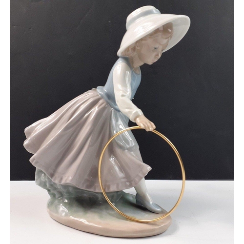 207 - A pretty NAO young girl playing with hoop, stands 20cm high, in good condition#207