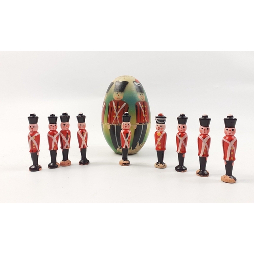 239 - A set of nine skittles - vintage hand-painted Nutcracker Suite wooden soldiers inside a nesting egg ... 