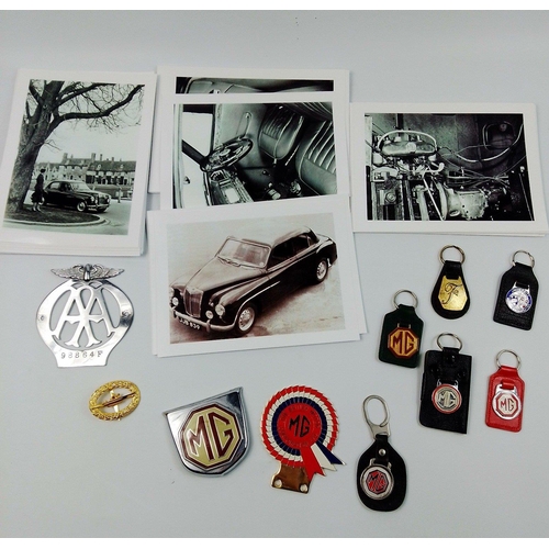 245 - A great collection of MG keyrings and car badges.  Includes an AA badge and others.  Includes a larg... 