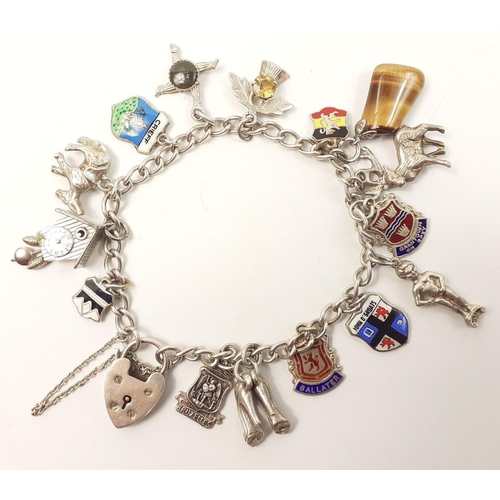 30 - A charm bracelet with silver charms on unmarked chain#30