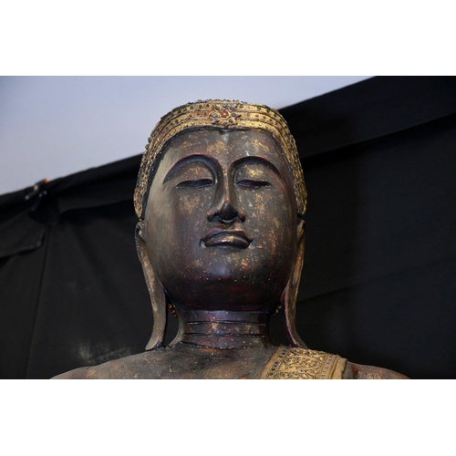 303 - An incredible 9ft high hand made wood carving of a Buddha hand decorated and finished with gold deta... 