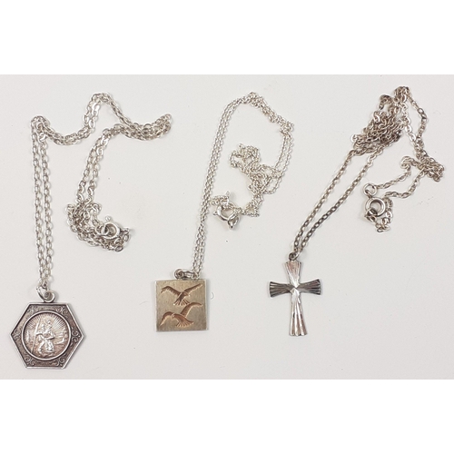 31 - Three silver marked chains, to include a St Christopher, a crucifix and a dove of peace motif. All o... 