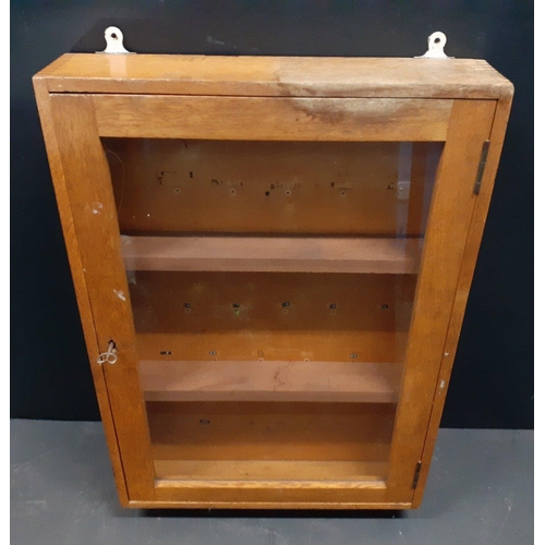 372 - A substantial wooden wall-mounted display cabinet previously functioned as a key cabinet.  Complete ... 