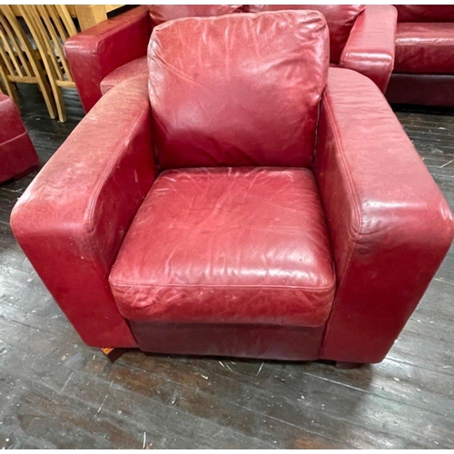 399 - Part of suite: A stylish RED LEATHER/HIDE armchair and footstool. This lot will be bypassed if full ... 