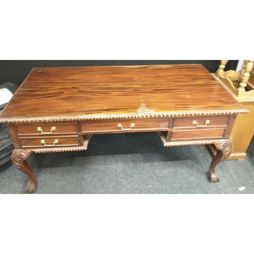 400 - A low wooden desk with central drawer, 2 sets of 2 side drawers all on ball and claw feet. Approx 16... 