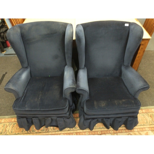 402 - A pair of mid-century PARKER KNOLL winged armchairs with skirted blue fabric finish.  Purchased in t... 