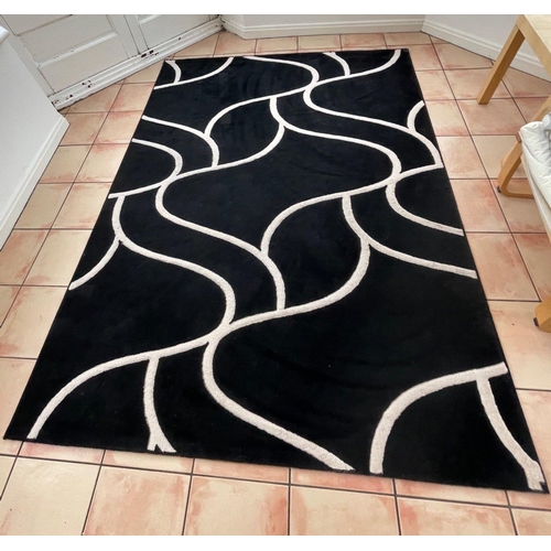 407 - A STUNNING modern scatter rug with a black background and white wavy design - 8ft x 6ft approx#410... 