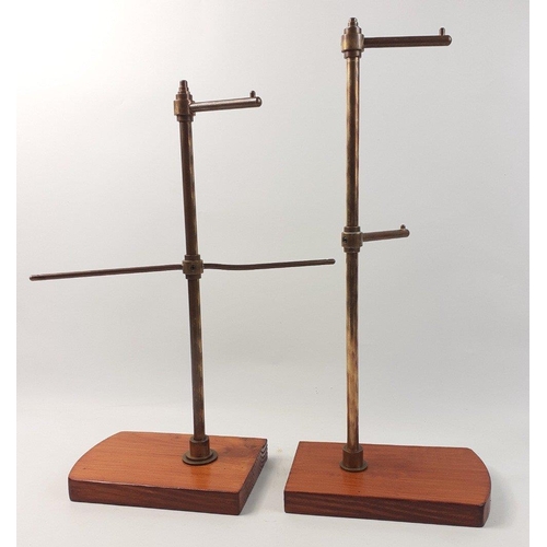 410 - A pair of haberdashery shop display stands in brass on modern wooden stands. Stand 45cm tall#413