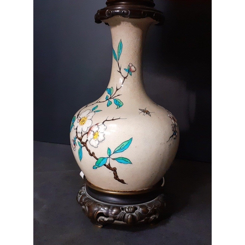 436 - An Oriental style lamp converted to electric, garnished with butterflies.  Lamp stands approx 40cm w... 