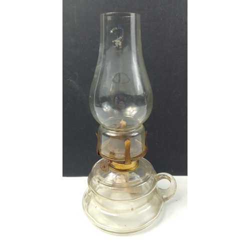 437 - A vintage small hand-held oil lamp complete with wick and chimney standing 26cm tall#440