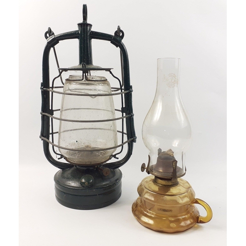 438 - A vintage, overpainted, oil storm lamp, intact glass embossed 'British Manufacture' and a small oil ... 