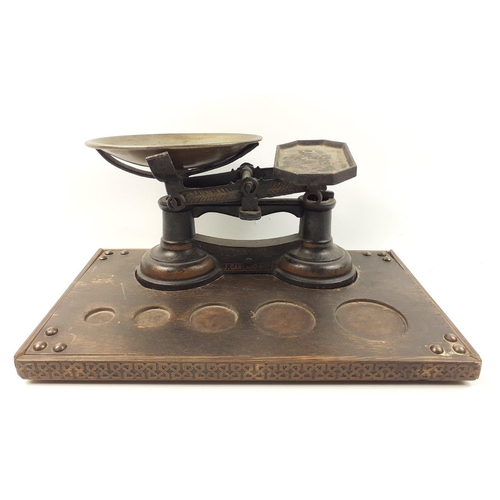 519 - A set of balance scales with pan by J GARLAND & CO set on a plinth with space for weights, base ... 