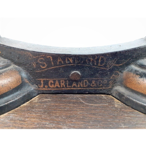 519 - A set of balance scales with pan by J GARLAND & CO set on a plinth with space for weights, base ... 