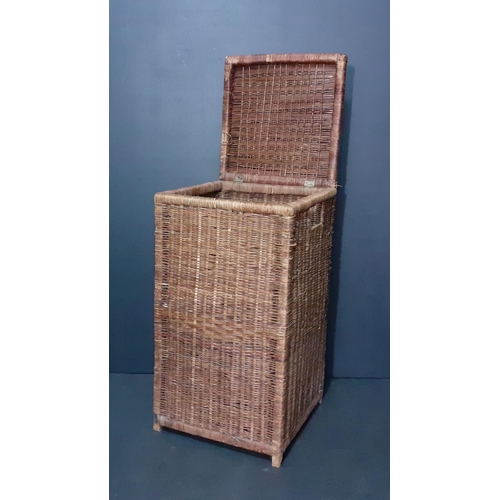 556 - A tall wicker basket measures 60x32x32.  Some loss to the wicker from use but overall  good conditio... 