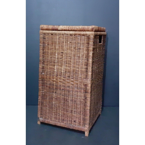 556 - A tall wicker basket measures 60x32x32.  Some loss to the wicker from use but overall  good conditio... 