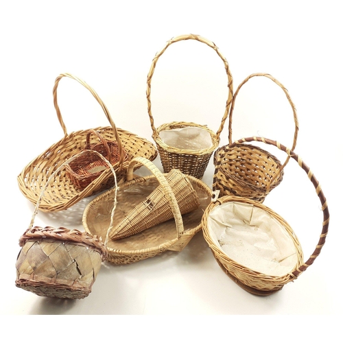 560 - A collection of eight wicker flower arranging baskets in various sizes#563