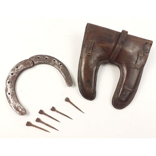 91 - A lovely WWI cavalry officer's repair kit in leather case comprising a hinged folding horse shoe and... 