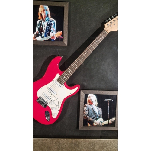 298 - A framed guitar bearing the original signature of the famous musician TOM PETTY. Framed in a wonderf... 