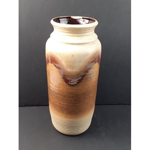 179 - A West German pottery vase.  Light brown / beige colourway and stands 40cm high.  A/F crack to top r... 